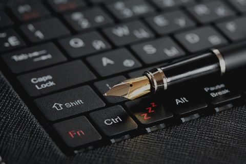 Pen resting on top of a laptop